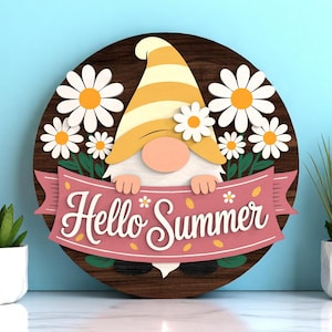 May include: A wooden round sign featuring a gnome with a yellow and white striped hat, surrounded by white daisies with orange centers. The sign has a pink banner that reads "Hello Summer".
