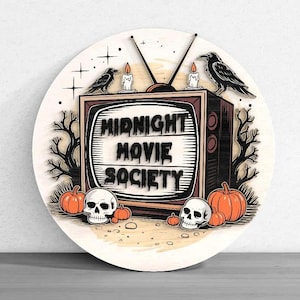 May include: Round wooden sign with a vintage television design. The sign features the text "MIDNIGHT MOVIE SOCIETY" in a retro font, with crows, candles, pumpkins, and skulls. The design has a Halloween theme.