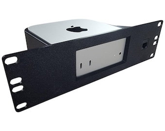 May include: A black rack mount for a Mac Mini computer. The rack has a rectangular design with a silver faceplate and a black frame. The Apple logo is visible on the top of the Mac Mini.