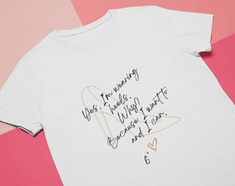 May include: White t-shirt with a black and gold graphic of a high heel shoe. The text on the shirt reads "Yes. I'm wearing heels. Why? Because I want to and I can. 6."