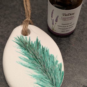 May include: A white ceramic mug with a black handle and the text "But First, Coffee" in a bold, black font. The mug is set against a neutral background, highlighting its simple design.