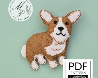 May include: A felt corgi dog craft project featuring brown and white fabric pieces joined with visible blanket stitching. The design includes black embroidered eyes, nose, and mouth. A circular logo reads M P MISU PATTERNS and a white box displays PDF PATTERN + instructions.