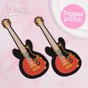 May include: Two embroidered guitar patches. The patches feature a black body with a red center and gold accents. The guitar neck is white and gold. The text "Patch Pop" is in pink script. A pink circle with the words "bigger patch" is in the upper right.