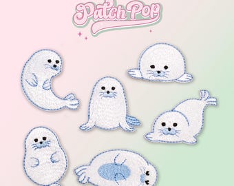 May include: Six white embroidered iron-on patches of seals in various poses. The patches are on a pink and green background with the text "Patch Pop" in a retro font.