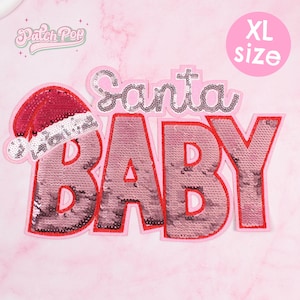 May include: A pink XL size sequined patch with the words "Santa BABY" in a playful font. The patch features a Santa hat on the left side. The text "Patch Pop" is in the upper left corner.