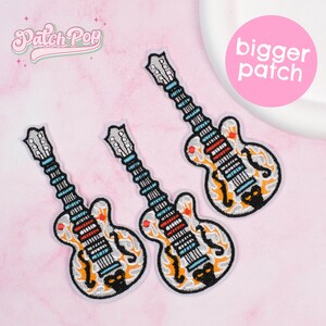 May include: Three embroidered guitar patches with a white base, black outlines, and colorful details. The patches feature a stylized design with orange flames, red accents, and blue fretboards. The text "Patch Pop" is in the upper left corner.