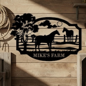 May include: Black metal farm sign featuring two horses, a tree, and the text "MIKE'S FARM." The sign is mounted on a wooden background, with a rope and other rustic elements visible.