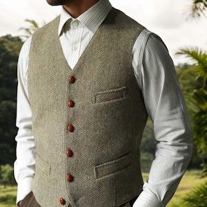 May include: A green and brown tweed waistcoat with a V-neck and four brown buttons. It has two front pockets and is worn over a white striped shirt. The style is classic and tailored, suitable for smart casual wear.