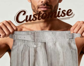 May include: Light gray linen pants with a buttoned pocket and adjustable side buckles. The word "Customise" is written in a brown script font above the pants. The pants are held up by a person.