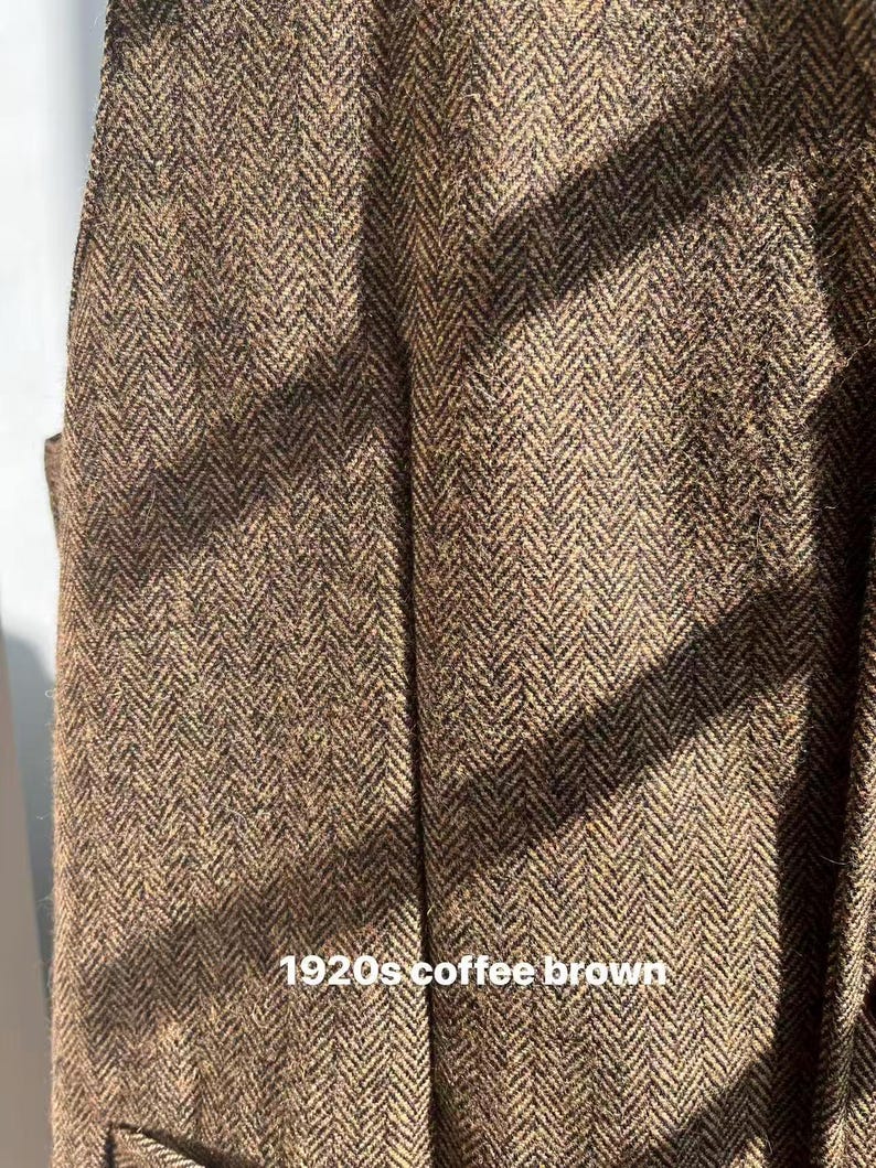May include: Close-up of a brown herringbone fabric with a coffee brown hue. The fabric has a textured appearance with a repeating V-shaped pattern. The text "1920s coffee brown" is visible at the bottom of the image.