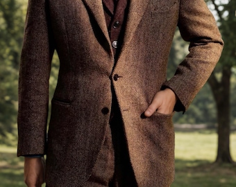May include: A brown herringbone tweed blazer and matching trousers worn over a dark burgundy waistcoat, a blue collared shirt, and a textured dark red necktie. The blazer features two dark buttons, notched lapels, and two front patch pockets.