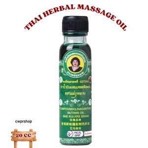 May include: A green glass bottle of Thai Herbal Massage Oil with a black cap. The label features a portrait and text in multiple languages, including "COMPOUNDCLINACANTHUS NUTANS OIL". The bottle is 20 ml.