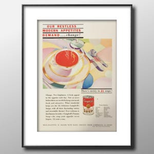 May include: Framed vintage advertisement for Campbell's Tomato Soup. The artwork features a bowl of soup, a spoon, and a can of soup. The text reads "OUR RESTLESS MODERN APPETITES DEMAND...change!" and "There's variety in 21 soups!"