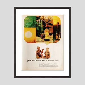 May include: Vintage advertisement for Kahlúa Black Russian. The image features a bottle of Kahlúa, glasses of the drink, and two small statues. The ad includes the text "Kahlúa Black Russian. What an intriguing idea."