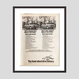 May include: Framed vintage advertisement for a Subaru 4-door sedan. The ad features two side-by-side images of the car, one stripped-down and one fully-equipped, with lists of features. Text reads "The front wheel drive Subaru."