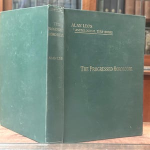 May include: A hardcover book titled "The Progressed Horoscope" by Alan Leo. The book is dark green with gold lettering. The spine reads "The Progressed Horoscope" and "Alan Leo". The cover also states "Alan Leo's Astrological Text Books".