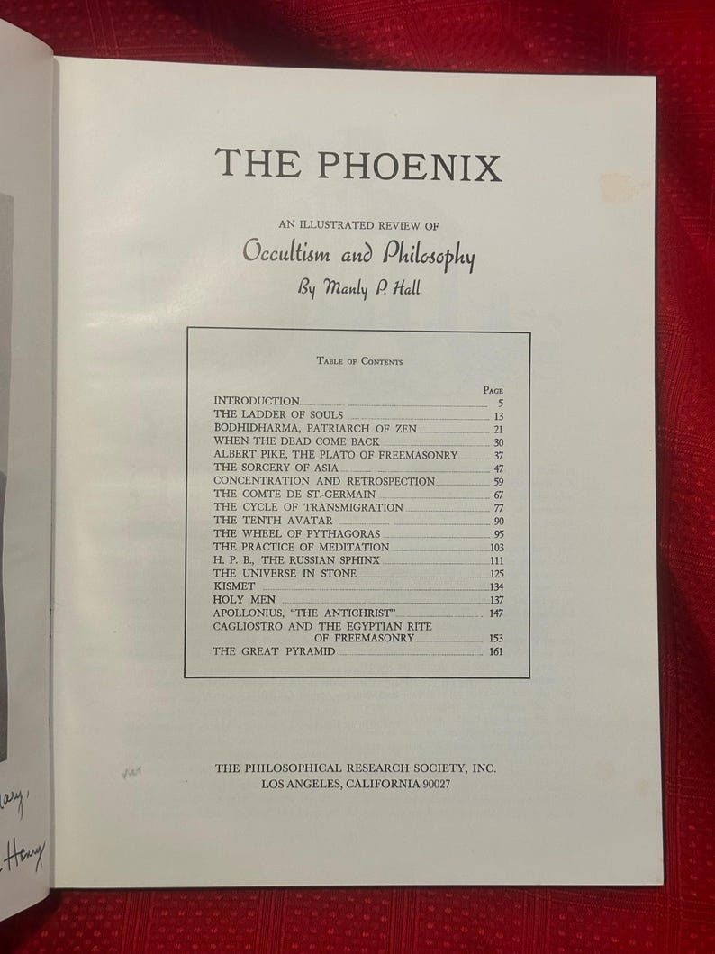 May include: An open book displaying the title "THE PHOENIX" and the subtitle "An Illustrated Review of Occultism and Philosophy" by Manly P. Hall. The table of contents includes chapters such as "The Ladder of Souls".