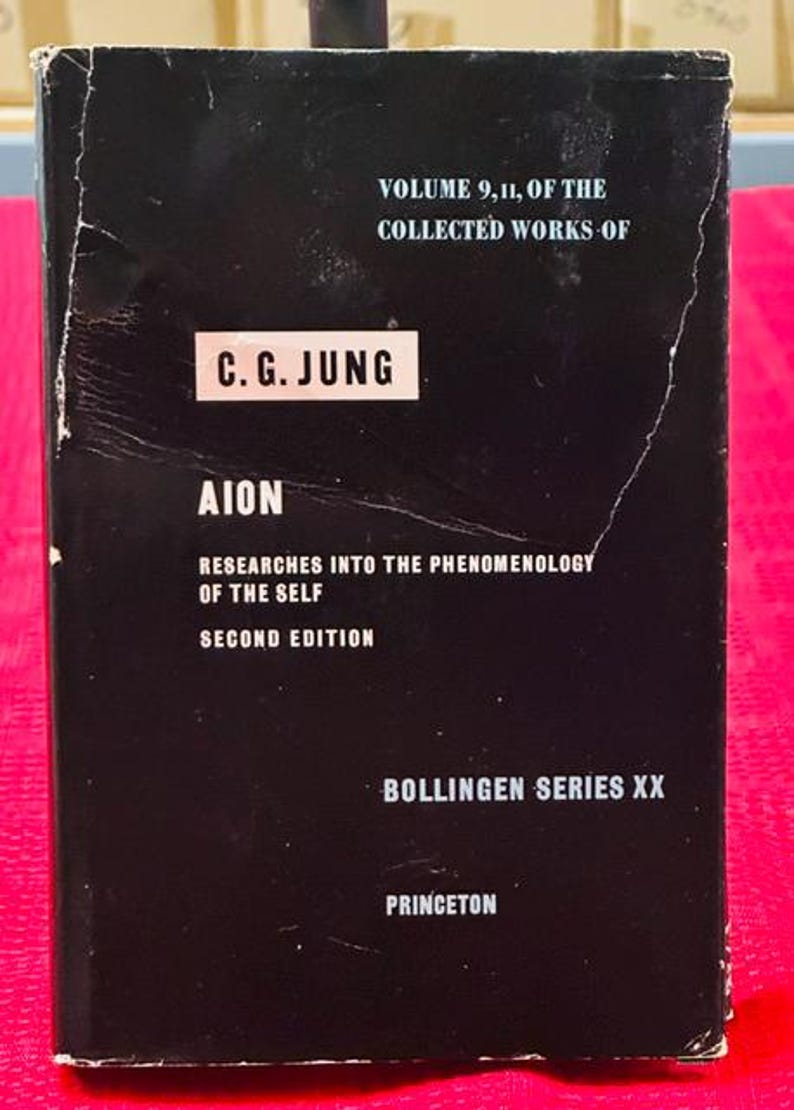 May include: A black book with white text. The cover reads "Volume 9, 11, of the Collected Works of C.G. Jung." The title "Aion" is displayed prominently, with "Researches into the Phenomenology of the Self" below it. The book is a second edition from Princeton.