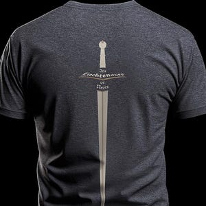 May include: Charcoal grey t-shirt with a sword graphic. The design includes a vertical sword with the text "It's Liechtenauer or Never". The text and sword are in a light colour, contrasting with the dark grey fabric of the t-shirt.