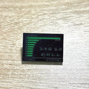 May include: Black and green enamel pin with a bar graph showing data points. The graph is labeled "PYT" and "GOAL".