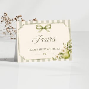 May include: A rectangular card with a cream background and light green vertical stripes. The card features a green bow at the top, the text Pears and PLEASE HELP YOURSELF in dark lettering, and a decorative illustration of a pear and white flowers.