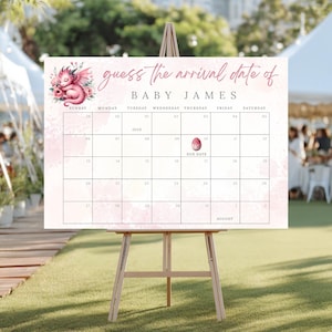 May include: A baby shower game board in pink and white, displayed on a wooden easel. The board has a calendar grid with the text "guess the arrival date of BABY JAMES." A pink dragon illustration is in the upper left corner.