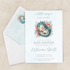 May include: Baby shower invitation featuring a watercolour illustration of a sleeping teal dragon surrounded by pink flowers. The text reads "a little dragon is on the way" and invites guests to a baby shower for Katherine Smith.