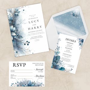 May include: A wedding stationery set with a watercolour floral design in blue and white. The set includes an invitation, details card, RSVP card, and an envelope. The invitation reads "The Wedding of Lucy and Harry".