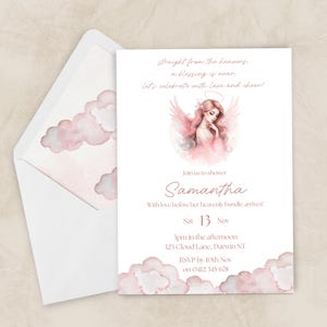 May include: A baby shower invitation featuring a watercolour angel illustration and pink cloud accents. The invitation includes the name "Samantha", date, time, and location. The envelope has matching cloud designs.