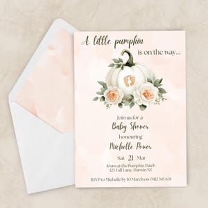 May include: Baby shower invitation with a watercolour design. The invitation features a white pumpkin with baby footprints, flowers, and the text "A little pumpkin is on the way..." The invitation is in a white envelope.