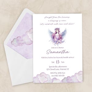 May include: A white invitation with a watercolor illustration of a woman with wings, and the name "Samantha". The invitation includes text: "Straight from the heavens, a blessing is near. Let's celebrate with love and cheer!" and RSVP information.