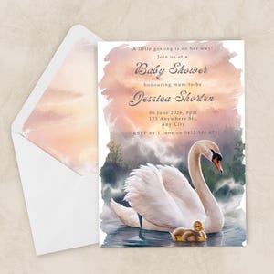 May include: Baby shower invitation with a swan and gosling watercolour illustration. The invitation includes event details, set against a soft, sunset-coloured background. An envelope with a matching design is also visible.