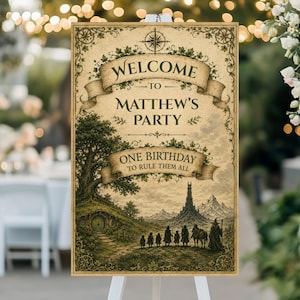 May include: A vintage-style party welcome sign with the text "Welcome to Matthew's Party" and "One Birthday to Rule Them All." The sign features a fantasy landscape illustration with a hobbit hole, a tower, and figures. The sign is on a white easel.