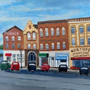 May include: An acrylic painting of a street scene featuring several buildings with shops and restaurants. The painting includes cars parked on the street and a blue sky. The painting is signed by the artist, Vivien Pollack.
