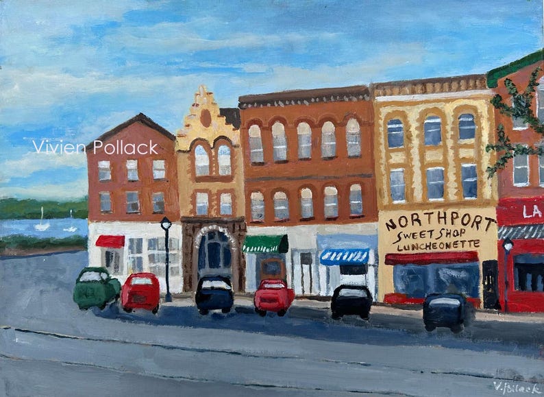 May include: An acrylic painting of a street scene featuring several buildings with shops and restaurants. The painting includes cars parked on the street and a blue sky. The painting is signed by the artist, Vivien Pollack.