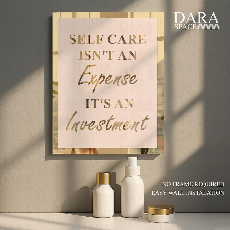 May include: A framed print with the text "SELF CARE ISN'T AN EXPENSE IT'S AN INVESTMENT" in gold lettering. Below the print are three white cosmetic containers with gold lids. The Dara Space logo is in the upper right corner.