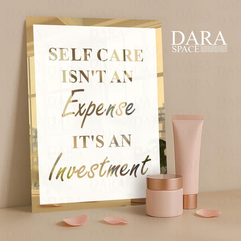 May include: A gold-framed print with the text "SELF CARE ISN'T AN Expense IT'S AN Investment" is displayed. Beside it are two pink cosmetic containers and a tube, with scattered pink petals. The Dara Space logo is in the upper right.