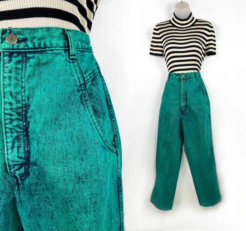 May include: Bright teal acid wash jeans with a high waist and a button closure. The jeans are paired with a black and white striped top. The jeans have a classic five-pocket design and a straight leg.