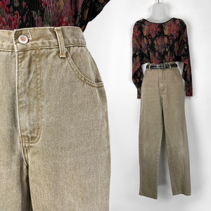 May include: A pair of high-waisted, light brown denim jeans. The jeans have a straight leg and a relaxed fit.
