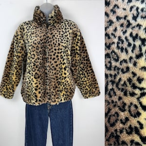 May include: A brown, black, and yellow leopard print fleece jacket with a zipper closure.