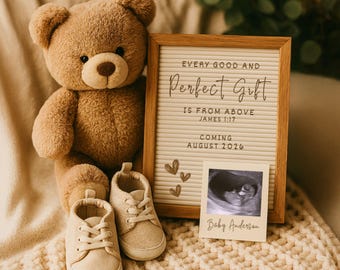 May include: A teddy bear, baby shoes, and a framed announcement with the text "Every Good and Perfect Gift Is From Above James 1:17 Coming August 2026" and a sonogram image. The announcement includes the name "Baby Anderson".