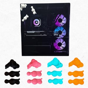 May include: A black computer case with a Radeon graphics card and colourful LED fans. Cloud-shaped accessories in black, pink, blue, and orange are displayed below the computer.