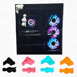 May include: A black computer tower with illuminated fans and a white cloud-shaped decoration. Below, there are sets of cloud-shaped decorations in black, pink, blue, and orange.