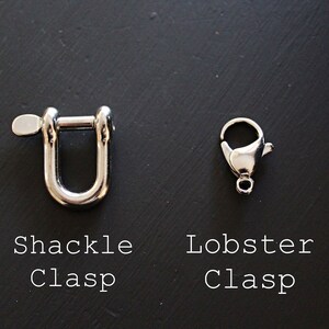 May include: Two metal clasps, one is a shackle clasp and the other is a lobster clasp. Both clasps are silver in color.