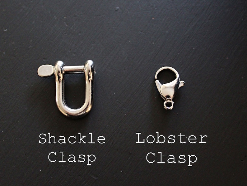 May include: Two metal clasps, one is a shackle clasp and the other is a lobster clasp. Both clasps are silver in color.