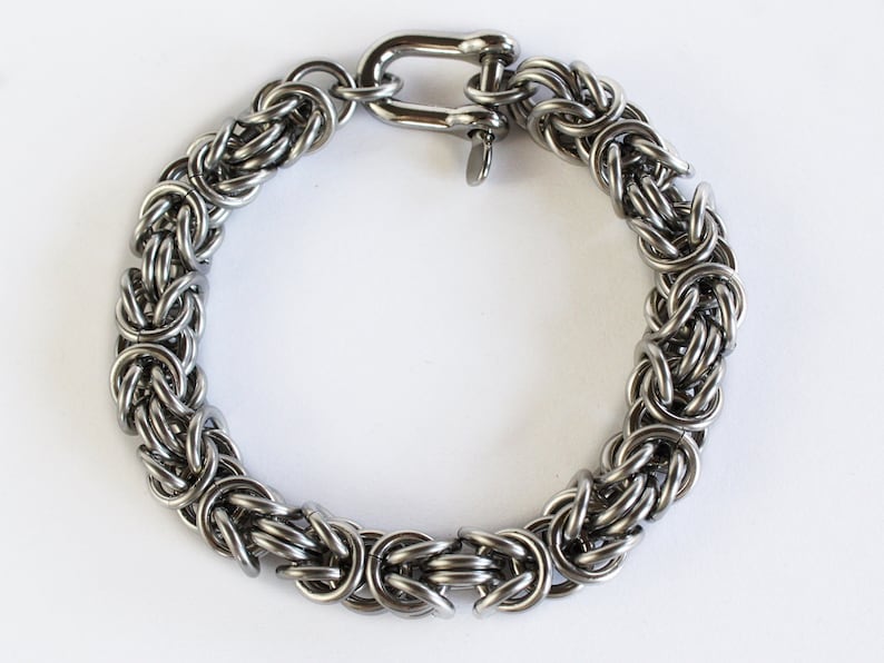 May include: A silver stainless steel bracelet with a chain link design and a lobster clasp.