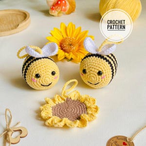 May include: A collection of crocheted items, including two yellow and black striped bee ornaments with white wings and smiling faces, and a sunflower. The image includes the text "CROCHET PATTERN".