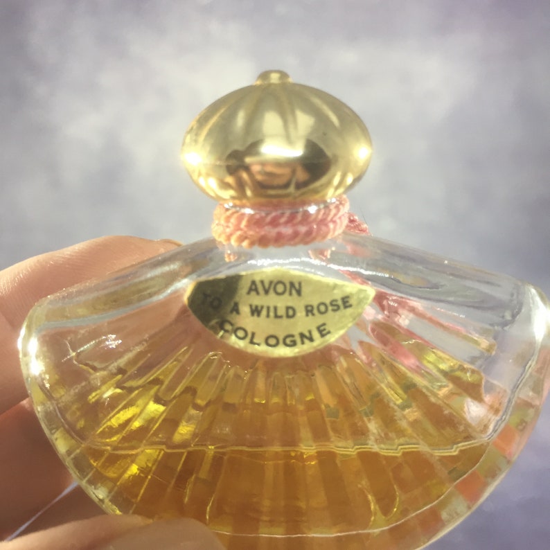 Avon Wild Rose Fan-Shaped Bottle and Other Round Glass Ribbed Bottle with Gold Dome Top