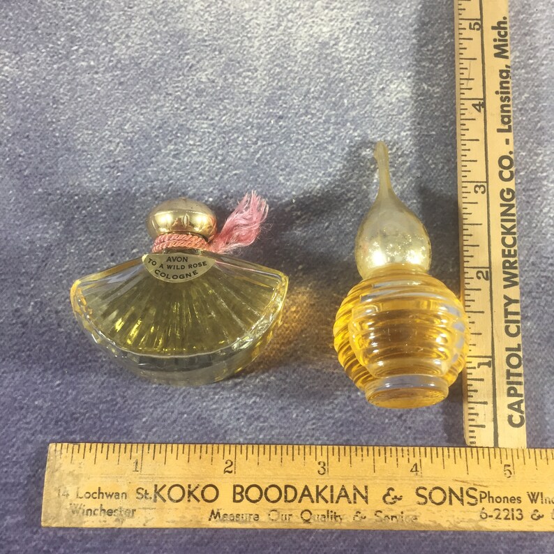 Avon Wild Rose Fan-Shaped Bottle and Other Round Glass Ribbed Bottle with Gold Dome Top