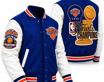 May include: A blue and white varsity jacket featuring New York Knicks branding. The front displays the team logo, while the back showcases a large graphic of a basketball trophy with the text Finals Champions and the NBA logo. The sleeves are white.